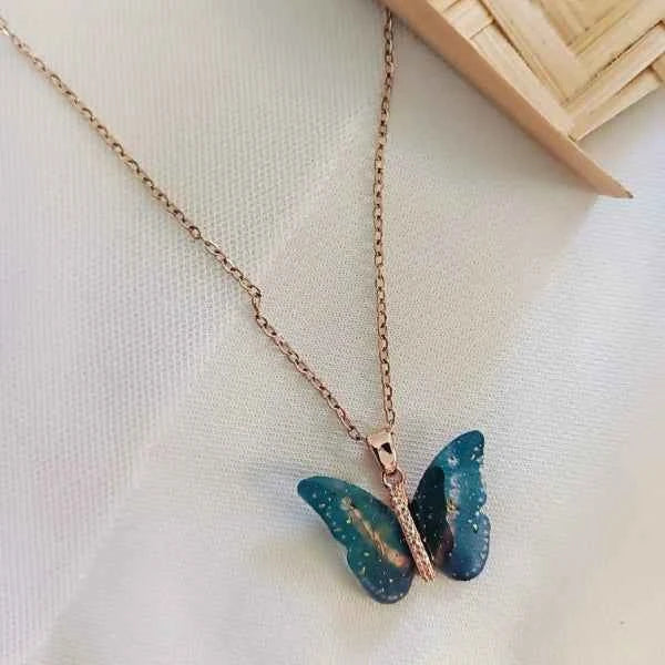 Ethereal Butterfly Resin Necklace – Rose Gold & Glittering Blue