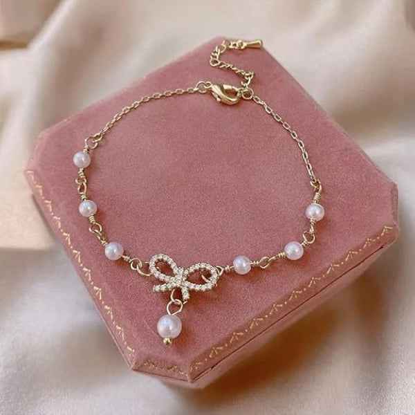 Radiant Gold Bow Pearl Dangle Bracelet | Polished Rhinestone Jewelry