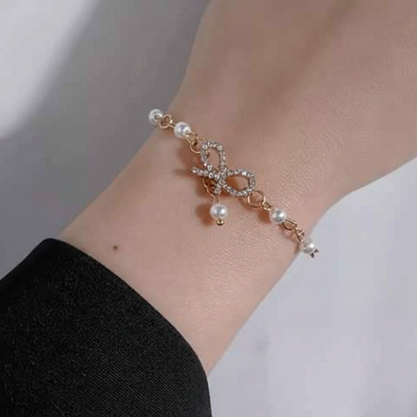 Radiant Gold Bow Pearl Dangle Bracelet | Polished Rhinestone Jewelry